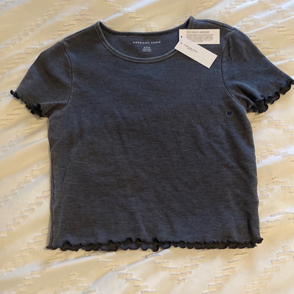 gray ish black ruffled tee super cute! brand new